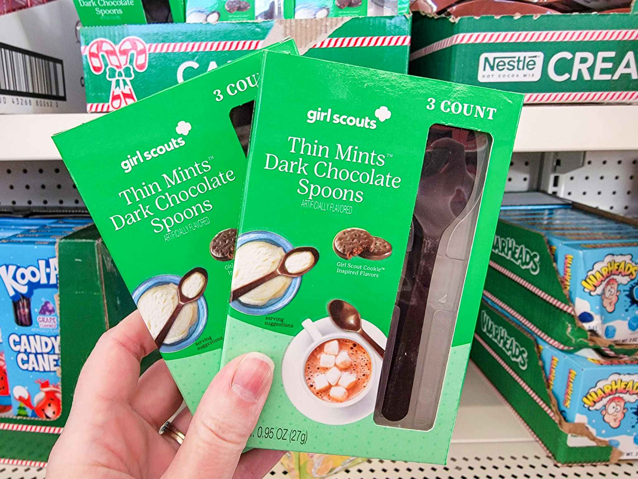 hand holding thin mints flavored spoons