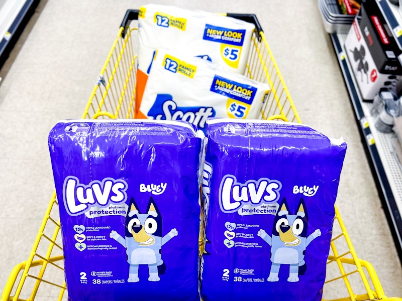 2 packs of diapers and 2 packs of toilet paper in a cart