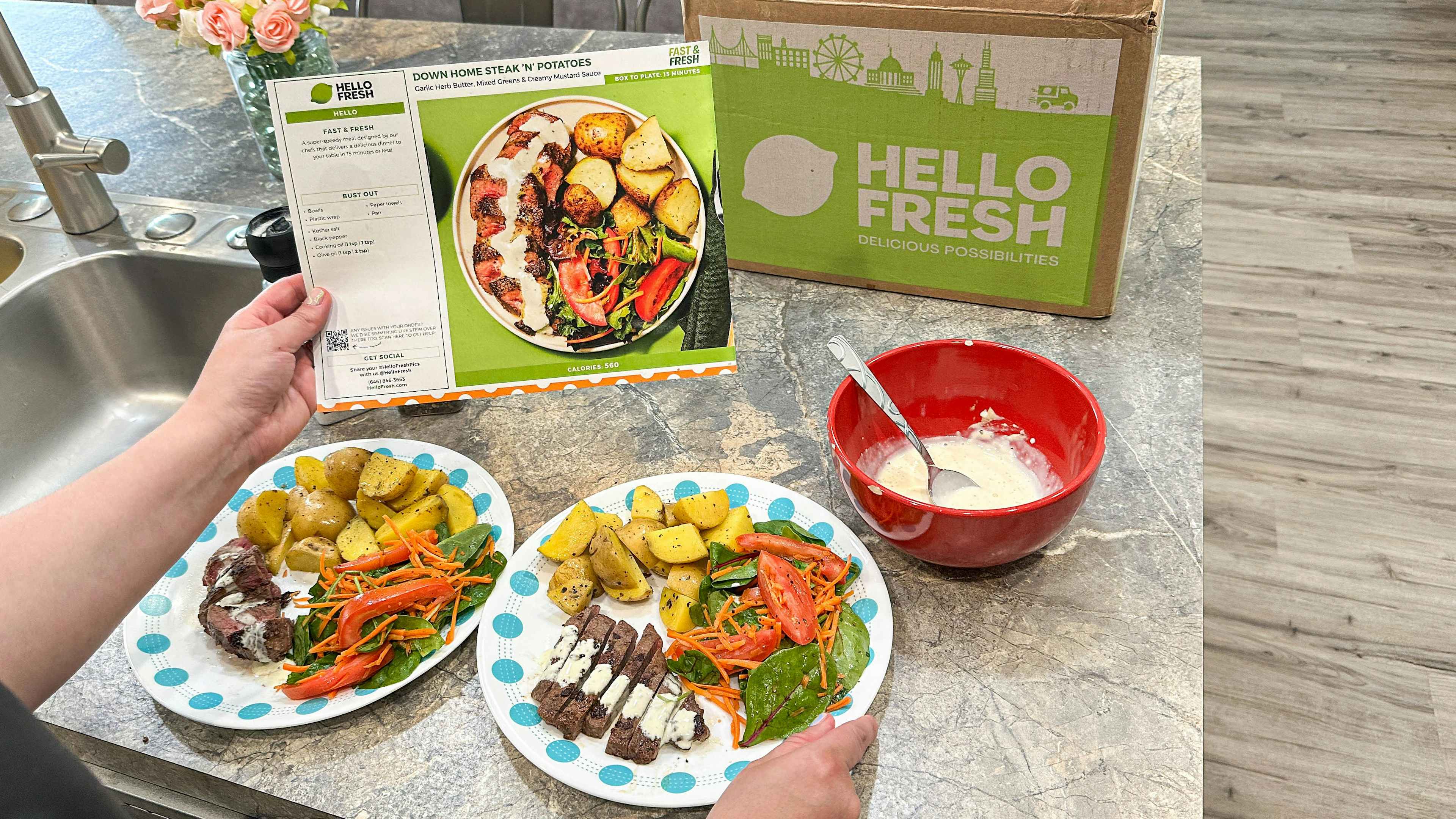 steak and potatoes meal on plate with hello fresh recipe card next to it