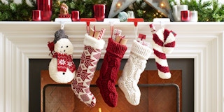 Pottery Barn stockings hanging together above a fireplace