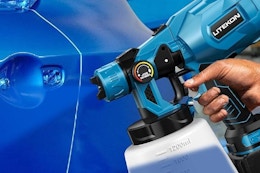 a cordless paint sprayer spraying on a car