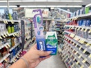 hand holding crest and oral-b items in walgreens
