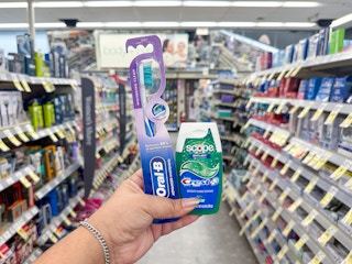 hand holding crest and oral-b items in walgreens