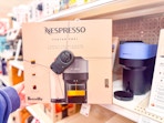 hand holding a nespresso coffee and espresso maker at target