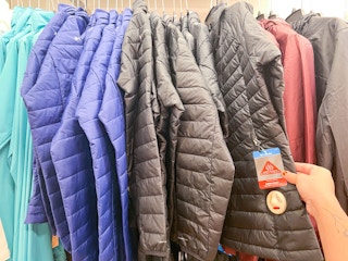 a row of columbia jackets hanging in macy's