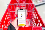 hand holding a smartphone displaying a 1-clip coupon in the kcl app 