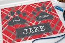 Red mat personalized with the name Jake and paw prints