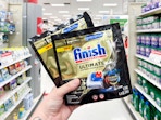 hand holding finish ultimate dishwasher tabs pack in a target aisle