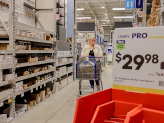 a person pushing a cart in lowes