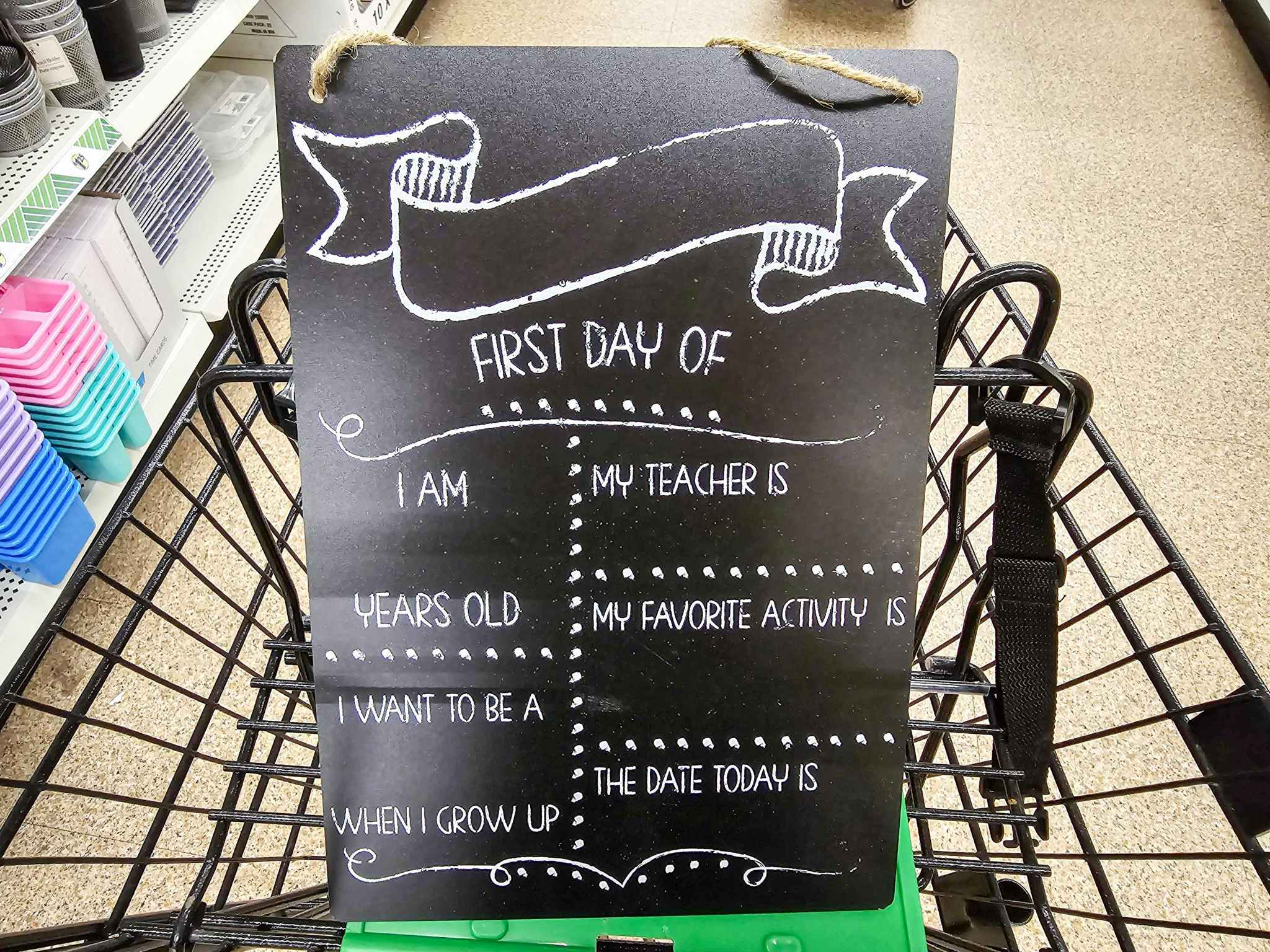 first day of school chalkboard sign in a cart