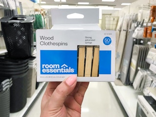 pack of wooden clothespins being held up at Target