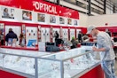 a person looking in a glass cases at Costco's Optical center