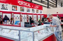 a person looking in a glass cases at Costco's Optical center