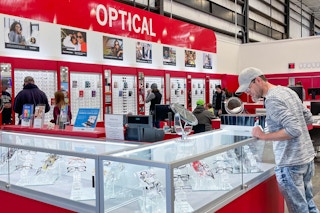 a person looking in a glass cases at Costco's Optical center