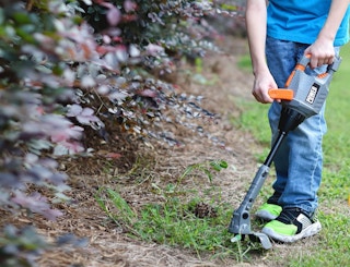 toy weed trimmer in the grass