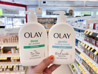 hand holding two olay face cleanser