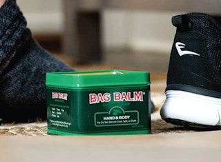 green body balm tin on the floor