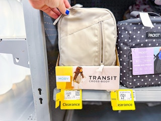 hand holding moby crossbody on walmart shelf