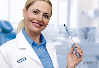 A dentist holding a toothbrush