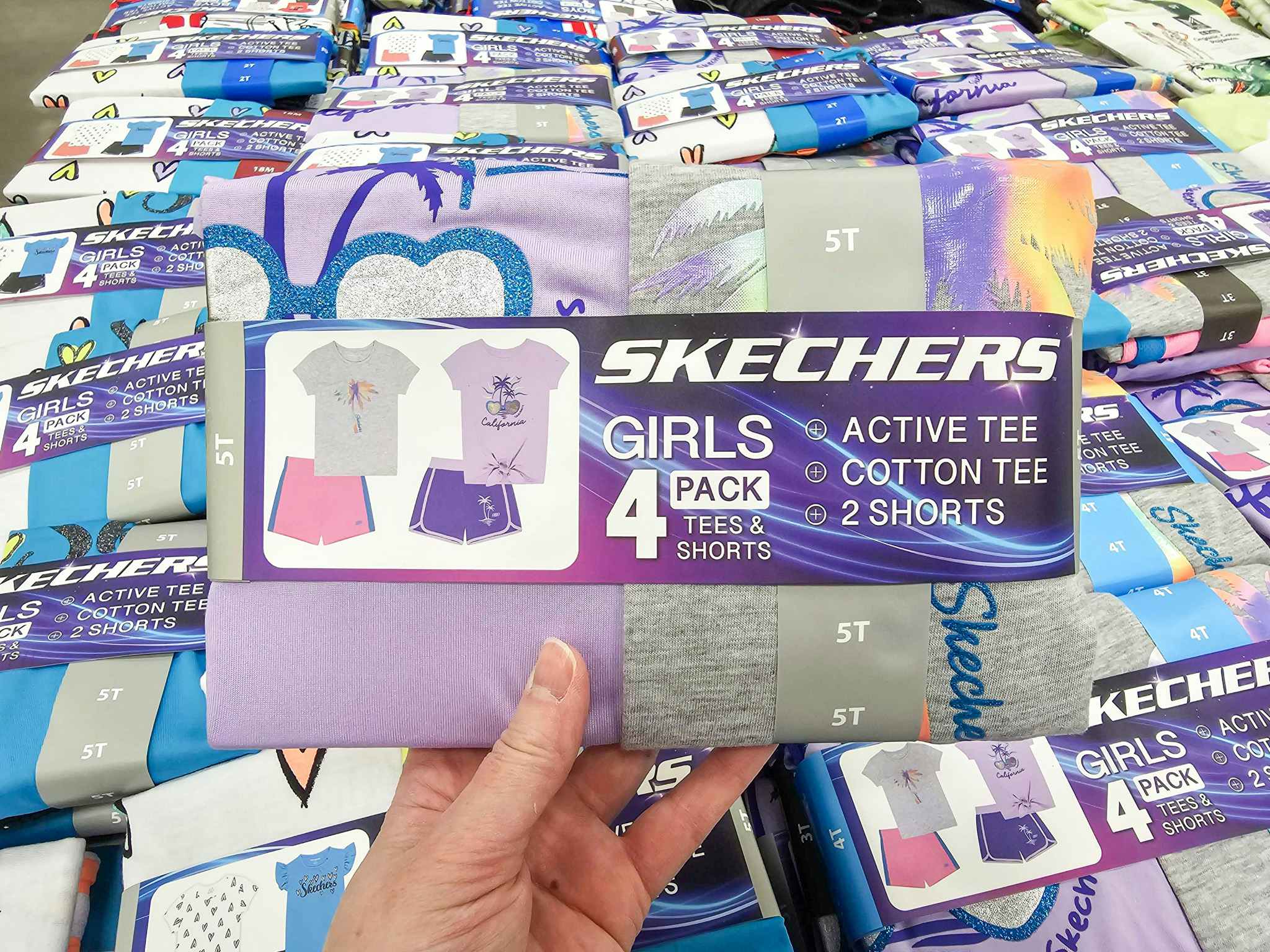 person holding a kids skechers outfit set