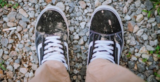 someone wearing a pair of dirty vans