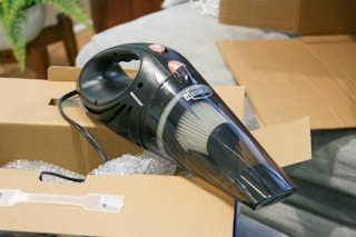 Corded car vacuum next to box