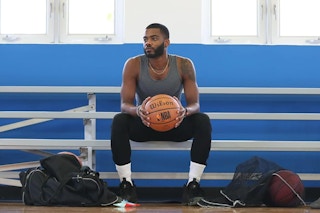 a man holding a wilson basketball