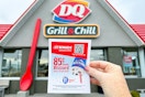 someone holding up an 85 cent blizzard flyer in front of dairy queen