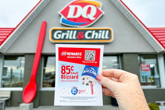someone holding up an 85 cent blizzard flyer in front of dairy queen