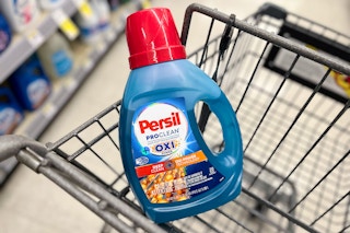 bottle of laundry soap in walgreens shopping cart in store aisle