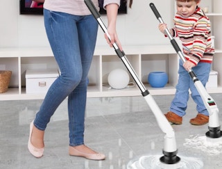 a mom and son cleaning a floor with a electric scrubber