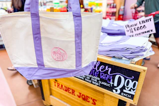 trader joes purple canvas tote bag and stocked store bin