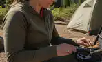 a woman opening a survival kit