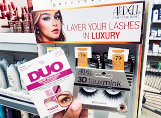 Box of Duo Striplash Adhesive and box of Ardell 3D FauxMink lashes in front of clearance tags on display stand