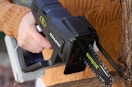 someone using a handheld chainsaw