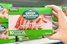 hand holding a box of green mountain kcups
