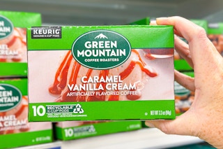 hand holding a box of green mountain kcups