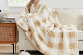 a woman with a throw blanket