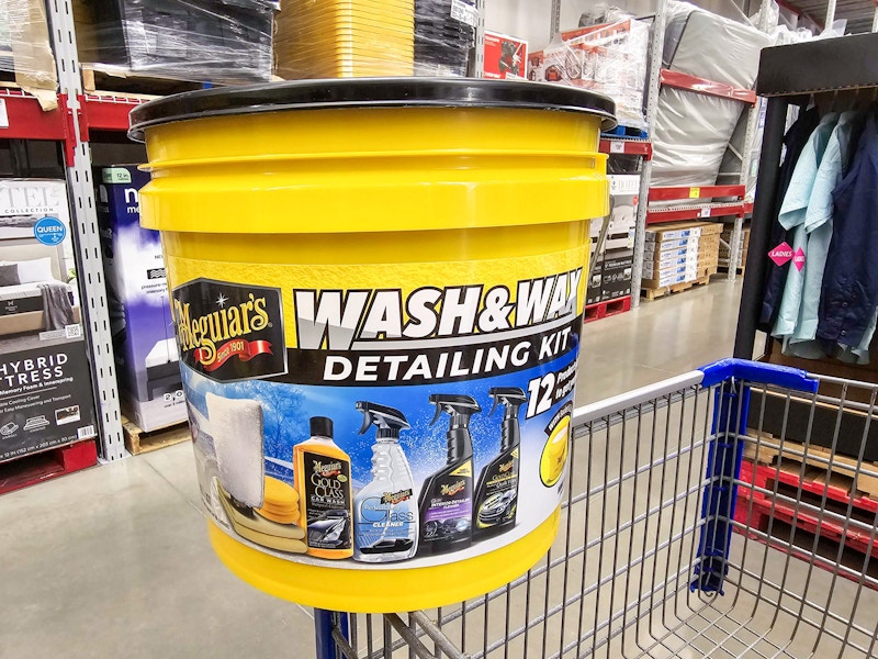 car detailing kit in a bucket on a shopping cart