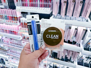 hand holding covergirl makeup in walgreens
