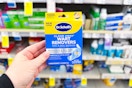 person holding a box of dr scholls wart remover bandages