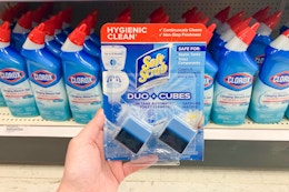 hand holding a pack of soft scrub toilet cleaner