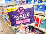 hand holding quilted northern toilet paper pack in cvs
