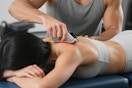 massage tool being used on back