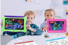 Boy and girl holding the MEJCFARI Magic LED Drawing Board for Kids.