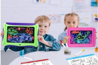 Boy and girl holding the MEJCFARI Magic LED Drawing Board for Kids.