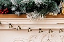 a bell garland over a fireplace
