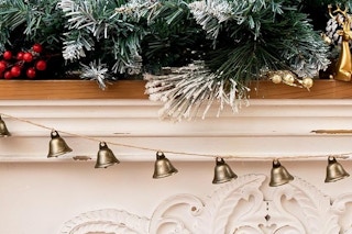 a bell garland over a fireplace
