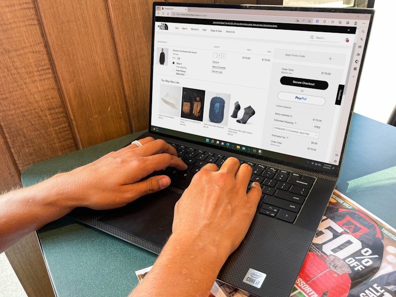 a woman on a laptop in cafe on the north face website 