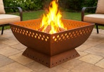 copper steel wood burning fire pit outside on a patio